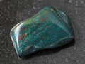tumbled green Heliotrope gem stone on dark Royalty Free Stock Photo