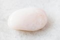 Tumbled Petalite rock on white marble Royalty Free Stock Photo