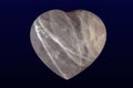 Tumbled and polished rose quartz heart on dark background Royalty Free Stock Photo