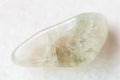 tumbled Prasiolite gemstone on white