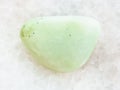 tumbled Prasiolite gemstone on white marble Royalty Free Stock Photo