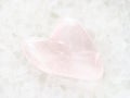 tumbled rose quartz stone in heart shape on white