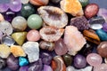 Tumbled and rough gemstones and crystals of various colors. Amethyst, geode amethyst, rose quartz, agate, apatite, aventurine, Royalty Free Stock Photo