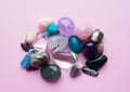 Tumbled and rough gemstones and crystals of various colors. Amethyst, rose quartz, agate, apatite, aventurine, olivine, turquoise Royalty Free Stock Photo