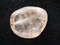 tumbled Rutilated Quartz gemstone on dark Royalty Free Stock Photo