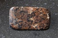 tumbled spreusteined urtite stone on dark Royalty Free Stock Photo
