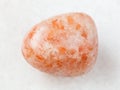 tumbled sunstone (heliolite) gem stone on white Royalty Free Stock Photo