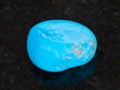 tumbled Turquenite (blue howlite) stone on dark