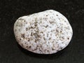 Tumbled of white Granite stone on dark background