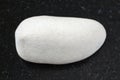 tumbled white Limestone gemstone on dark