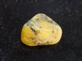 tumbled yellow Agate gemstone on dark background