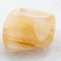 tumbled yellow banded Agate gemstone on white Royalty Free Stock Photo