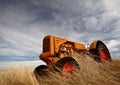 Tumbleweeds piled against abandoned tractor