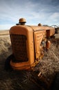 Tumbleweeds piled against abandoned tractor