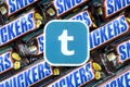 Tumblr paper logo on many Snickers chocolate covered wafer bars in brown wrapping. Advertising chocolate product in Tumblr social