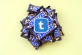 Tumblr paper logo on many Snickers chocolate covered wafer bars in brown wrapping. Advertising chocolate product in Tumblr social
