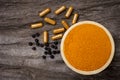 tumeric powder with curcuma capsule and black pepper peppercorns or piper nigrum