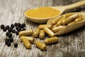 Tumeric capsule and blackpepper. Royalty Free Stock Photo