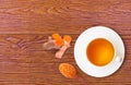 Cup of hot Turmeric tea isolated on wood table