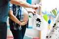 Tummy, happy pregnant couple who plays clothes in anticipation of a newborn baby, concept of love in the family Royalty Free Stock Photo