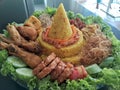 Tumpeng Nasi Kuning is a traditional Indonesian dish that not only tantalizes the taste buds but also holds a deep meaning Royalty Free Stock Photo