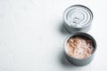 Tuna in a can, whole and chopped, in tin can, on white background, with copyspace  and space for text Royalty Free Stock Photo