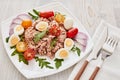 Tuna salad with arugula and tomatoes on light wooden background. Healthy food, seafood menu Royalty Free Stock Photo