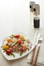 Tuna salad with arugula and tomatoes on light wooden background. Healthy food, seafood menu Royalty Free Stock Photo