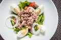 Tuna salad with eggs, tomatoes, salad leaves and onions