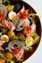 Tuna salad with fresh vegetables on a white napkin, classic nicoise in the author's presentation, canned tuna with Royalty Free Stock Photo