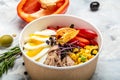 Tuna salad with tomatoes, corn olives, eggs and microgreen in paper bowl package for take away or food delivery, package for take