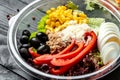 Tuna salad with tomatoes, corn olives, eggs in plastic package on black background. for take away or food delivery. Food recipe