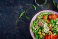 Tuna salad with tomatoes, olives, cucumber, sweet pepper and arugula Royalty Free Stock Photo