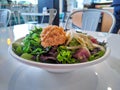 Tuna and salmon poke bowl, filled with avocado, mixed greens, rice, and other fresh crisp veggies Royalty Free Stock Photo