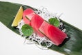 Tuna sashimi on white background. Traditional Japanese food. Raw yellow fin tuna fish served with decor. Sushi restaurant menu Royalty Free Stock Photo