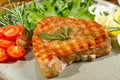 Tuna steak cooked on the electric grill. tunafish served on a plate with fresh herbs and vegetables. healthy nutritious