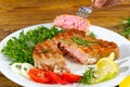 Tuna steak cooked on the electric grill. tunafish served on a plate with fresh herbs and vegetables. healthy nutritious