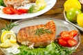 Tuna steak cooked on the electric grill. tunafish served on a plate with fresh herbs and vegetables. healthy nutritious