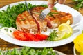 Tuna steak cooked on the electric grill. tunafish served on a plate with fresh herbs and vegetables. healthy nutritious