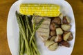 Tuna  steak  with asparagus and corn served with red roasted potatoes Royalty Free Stock Photo