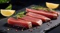 Tuna steak slices infused with fresh herbs on marble table Royalty Free Stock Photo