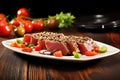 tuna steak topped with toasted sesame seeds on a square plate