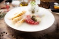 Tuna tartare: Guacamole quail egg baguette on a plate. Delicious healthy raw food closeup served for lunch on a table in