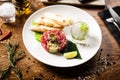 Tuna tartare: Guacamole quail egg baguette on a plate. Delicious healthy raw food closeup served for lunch on a table in