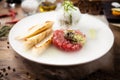 Tuna tartare: Guacamole quail egg baguette on a plate. Delicious healthy raw food closeup served for lunch on a table in