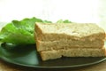 Tuna whole wheat bread sandwich with cos vegetable salad on plate