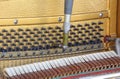 Tuner inside of a piano with little hammer