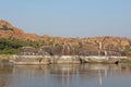 Tungabhadra river in the village of Hampi. Big stone. Tropical exotic landscape. Beautiful green valley. View from above