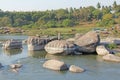 Tungabhadra river in the village of Hampi. Big stone. Tropical exotic landscape. Beautiful green valley. View from above