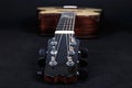 Tuning pegs on wooden machine head of six strings acoustic guitar neck on black background Royalty Free Stock Photo